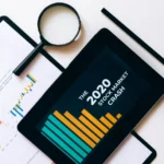 Clipboard with Statistical Data and Digital Tablet with Stock Market Display on Screen